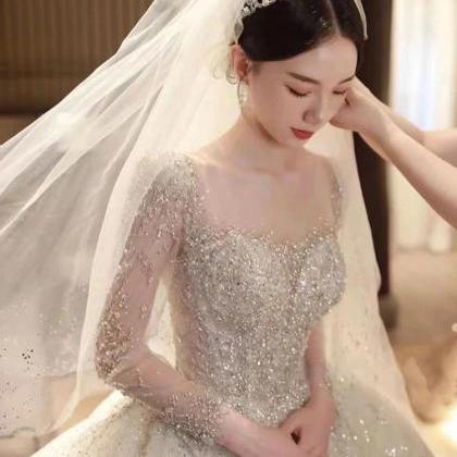 Elegant Long-sleeve Beaded Ball Gown Bridal Dress